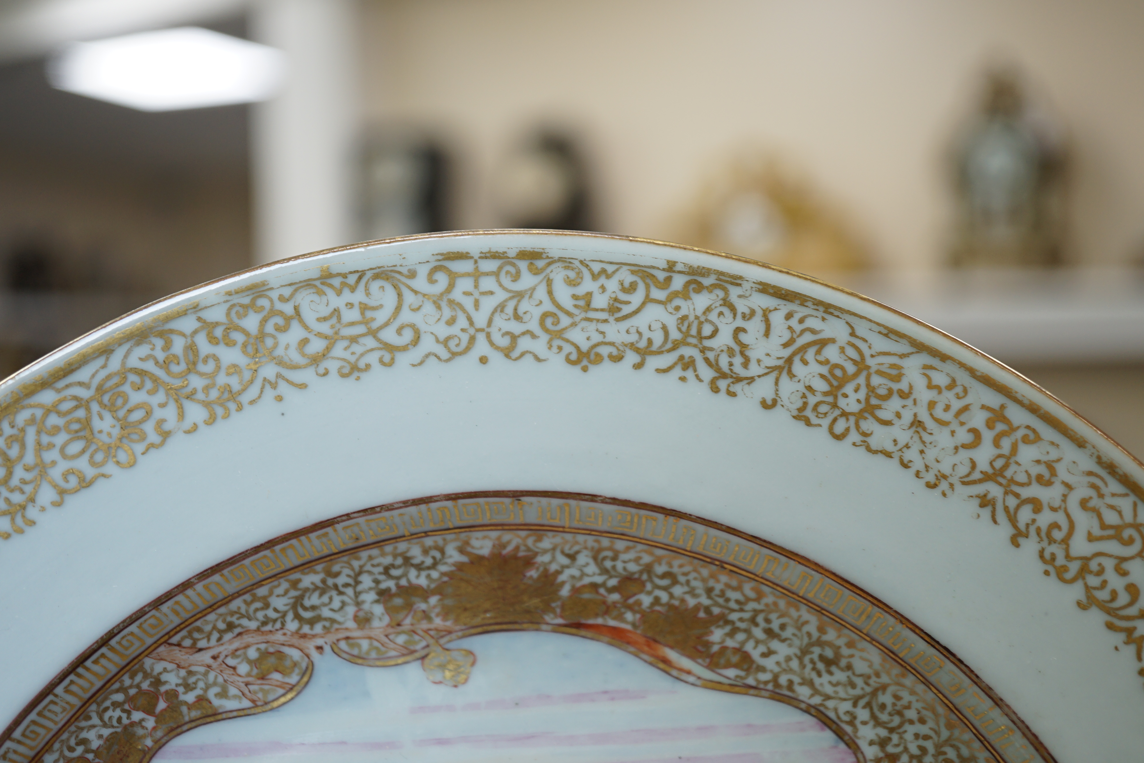 A pair of Chinese famille rose ‘landscape’ plates, Yongzheng-Qianlong period, small edge chip